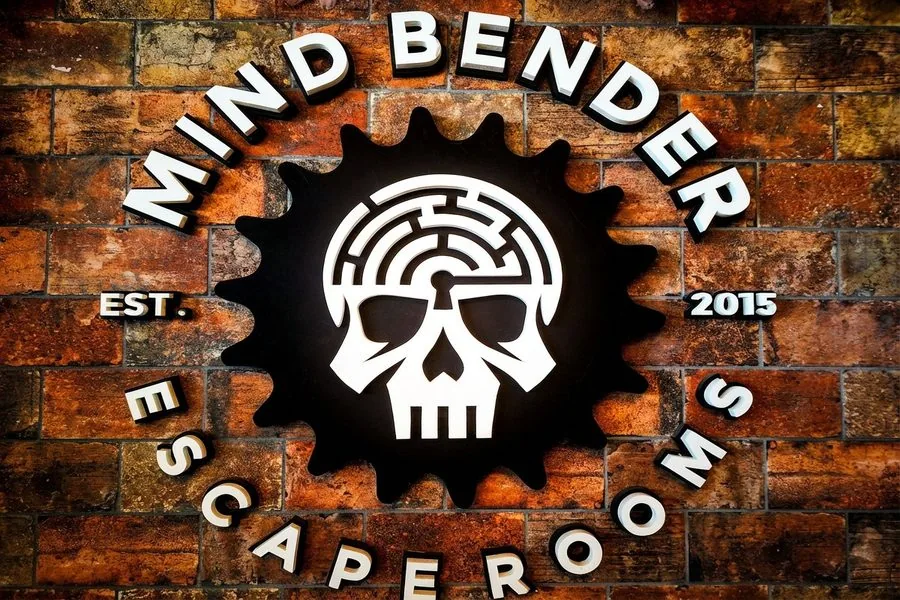 Mind Bender AR escape rooms logo on brick wall — established 2015