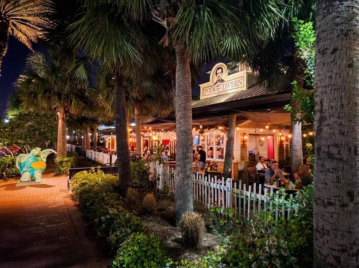 Poes Tavern at night with palm trees and lit outdoor patio in Atlantic Beach