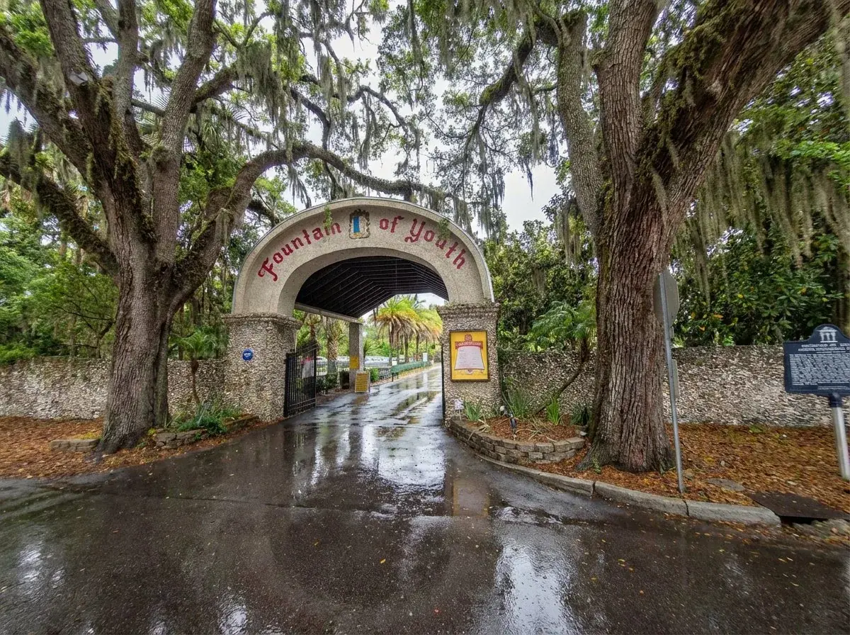 Fountain of Youth Archaeological Park entrance arch with oak trees and Spanish moss in St. Augustine Florida