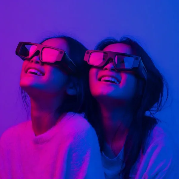 Two women wearing AR glasses looking up in wonder at Mind Bender AR experience Jacksonville